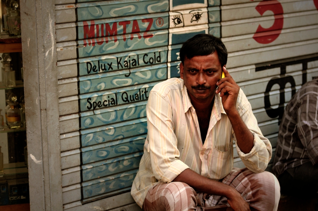 Photo of a man speaking in a phone in Mumbai, India.