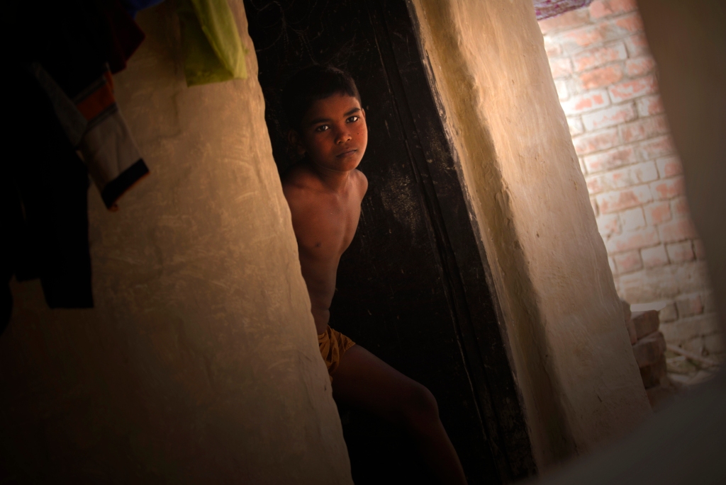 Photo of a boy in a village house in India.